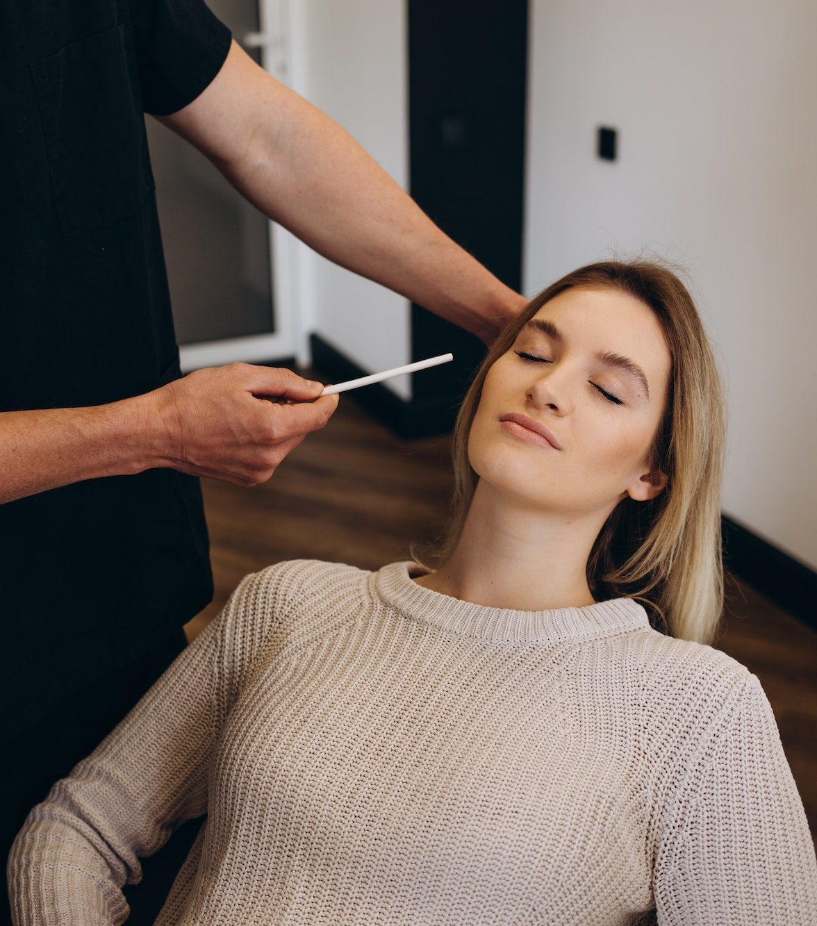 Young woman having meeting with plastic surgeon